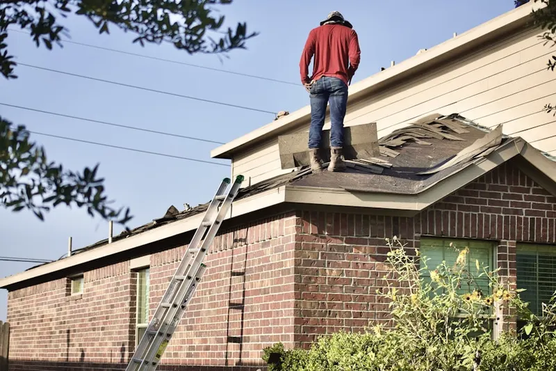 Professional roofer working on a residential roof in Skillman